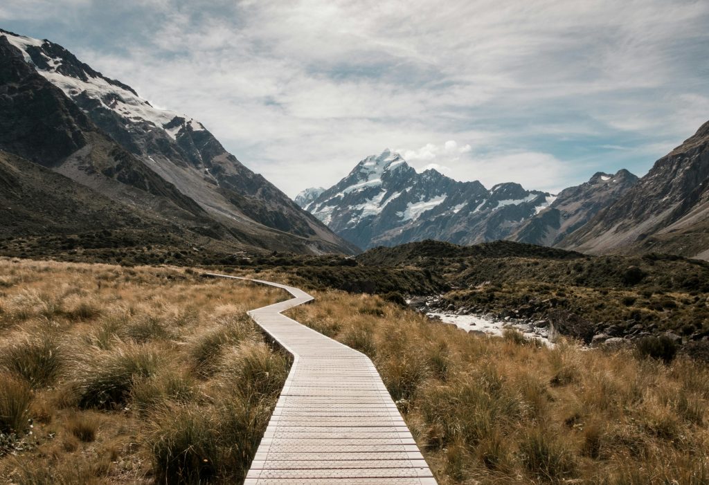 pexels-photo-808465-808465 Brown Wooden Dock Surrounded With Green Grass Near Mountain Under White Clouds and Blue Sky at Daytime